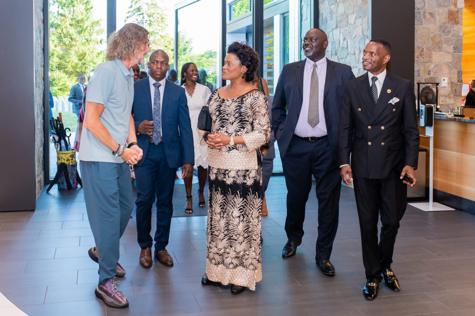 Ernie Boch Jr. warmly welcoming Prince Henry Edward Ssuuna, the Queen, and visiting guests