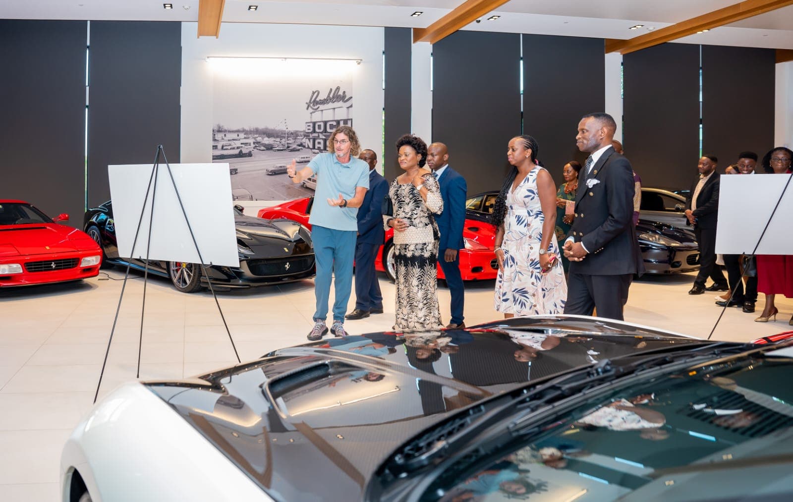 Ernie Boch Jr. welcoming Her Royal Highness the Nnaabagereka, Prince Henry Edward Ssuuna, and guests among the automotive collection