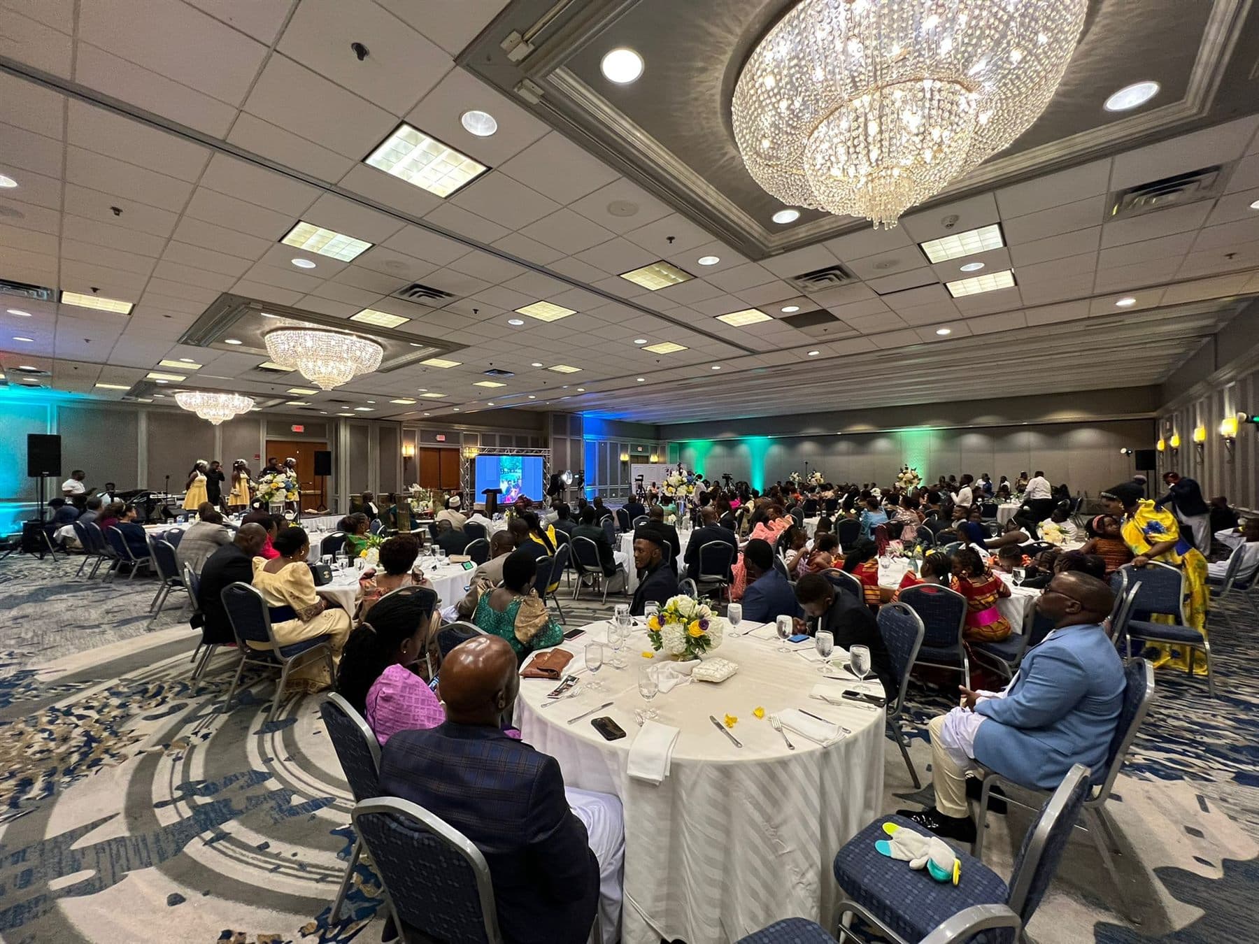 A second wide view of guests gathered in the Boston Marriott Newton ballroom