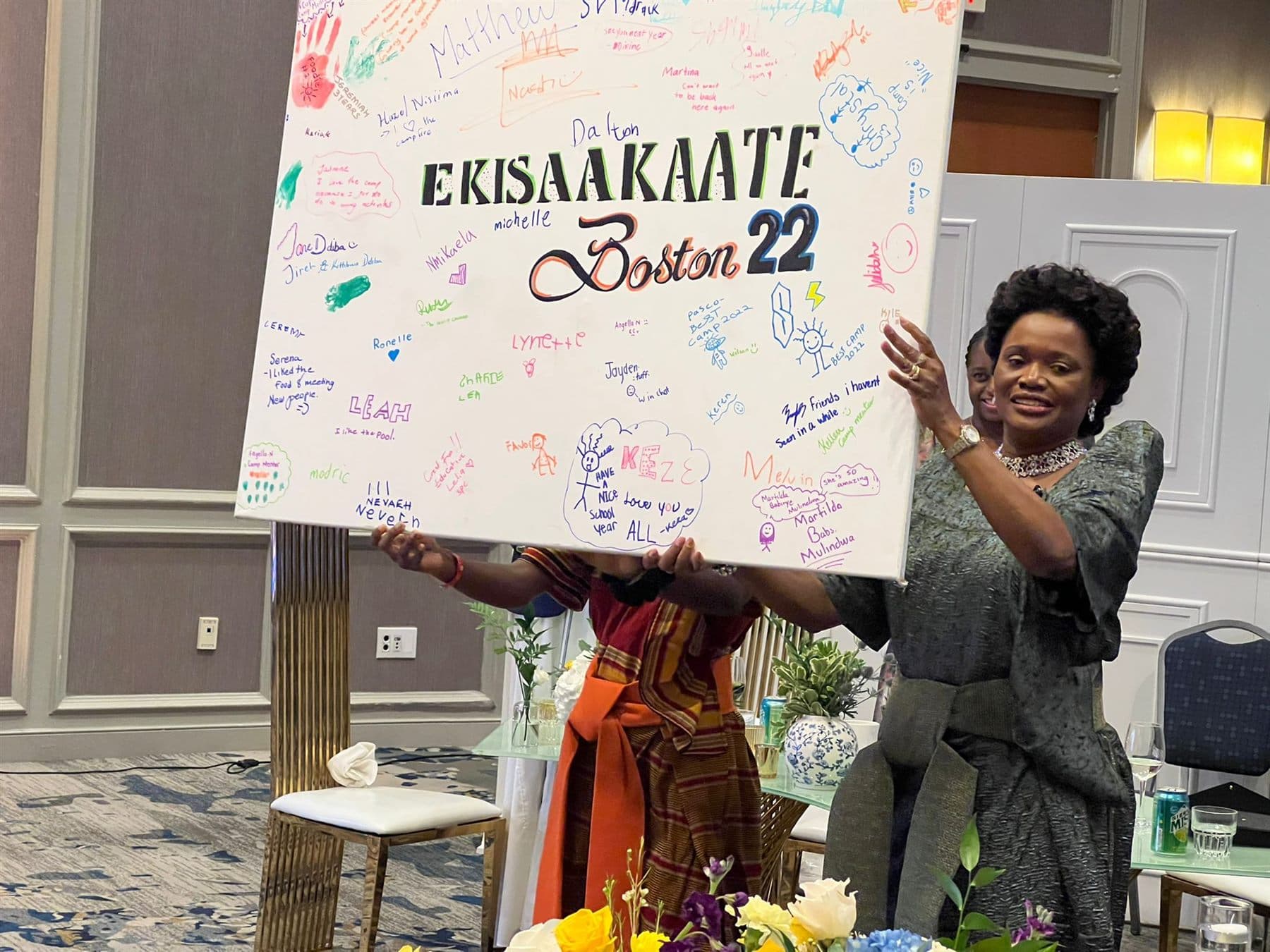 Her Royal Highness the Nnaabagereka unveiling a signed Ekisaakaate Boston 2022 memory board filled with participants' messages
