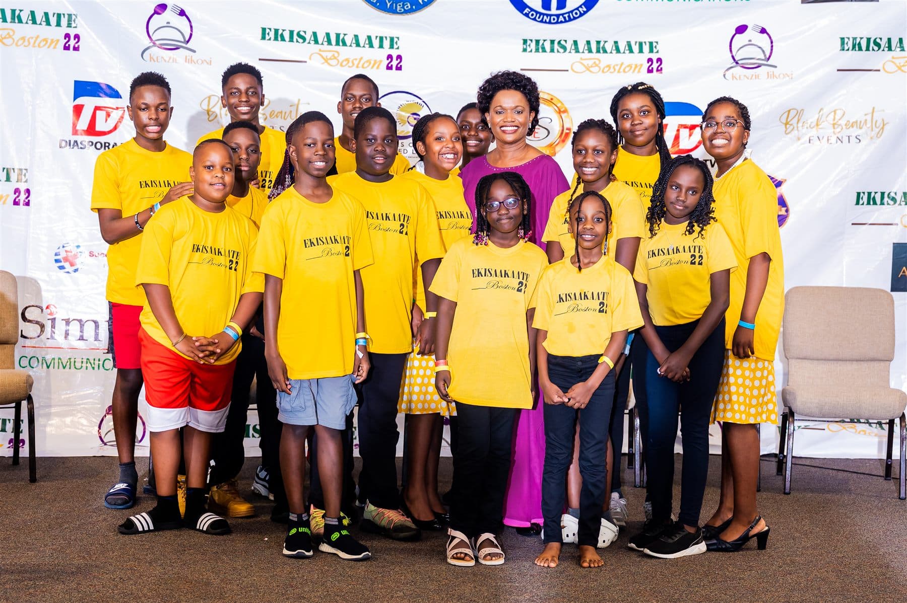 The yellow team photographed with Her Royal Highness the Nnaabagereka in front of the sponsors wall