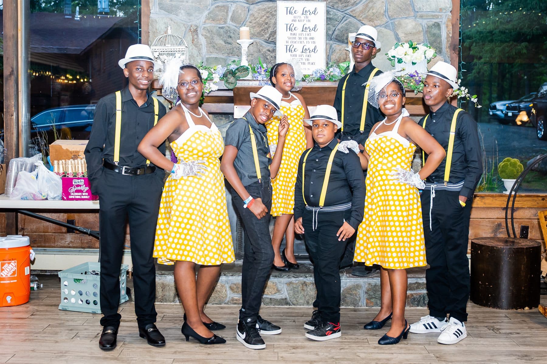 The performing ensemble posing together on stage after their number