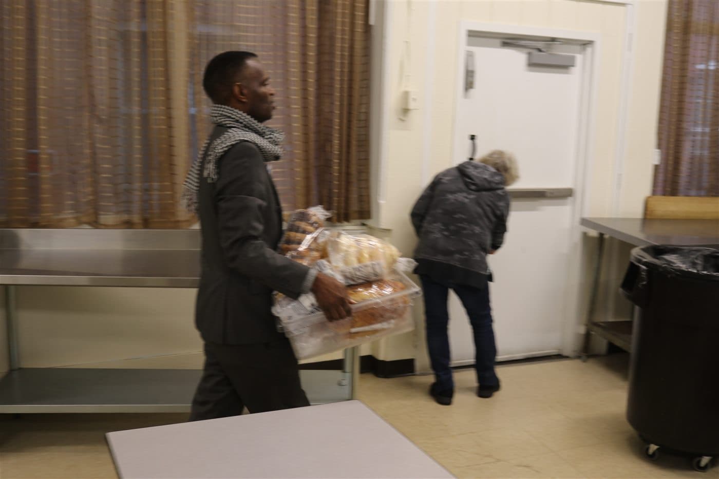 Volunteers bringing packaged bread into the preparation room