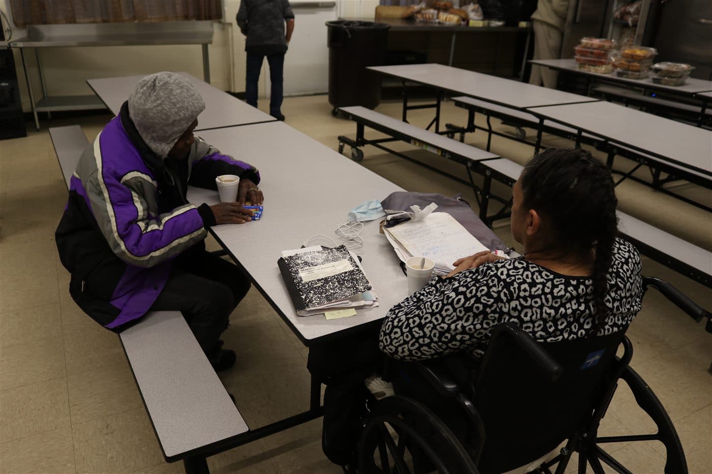 Community members seated in conversation around a table