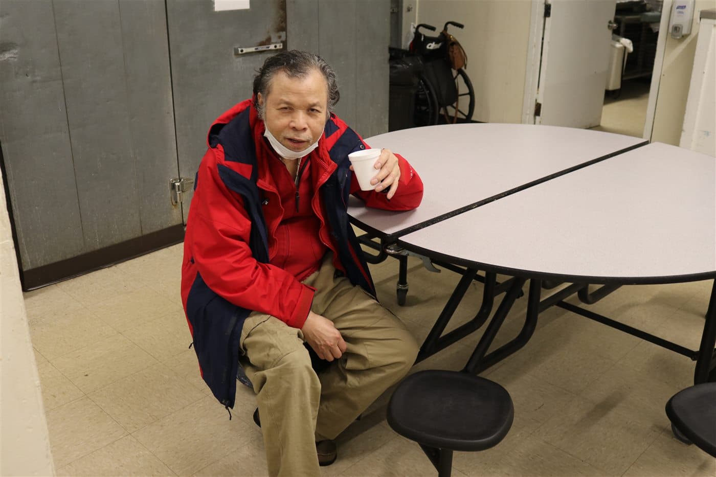 A community member seated at a table during the outreach gathering