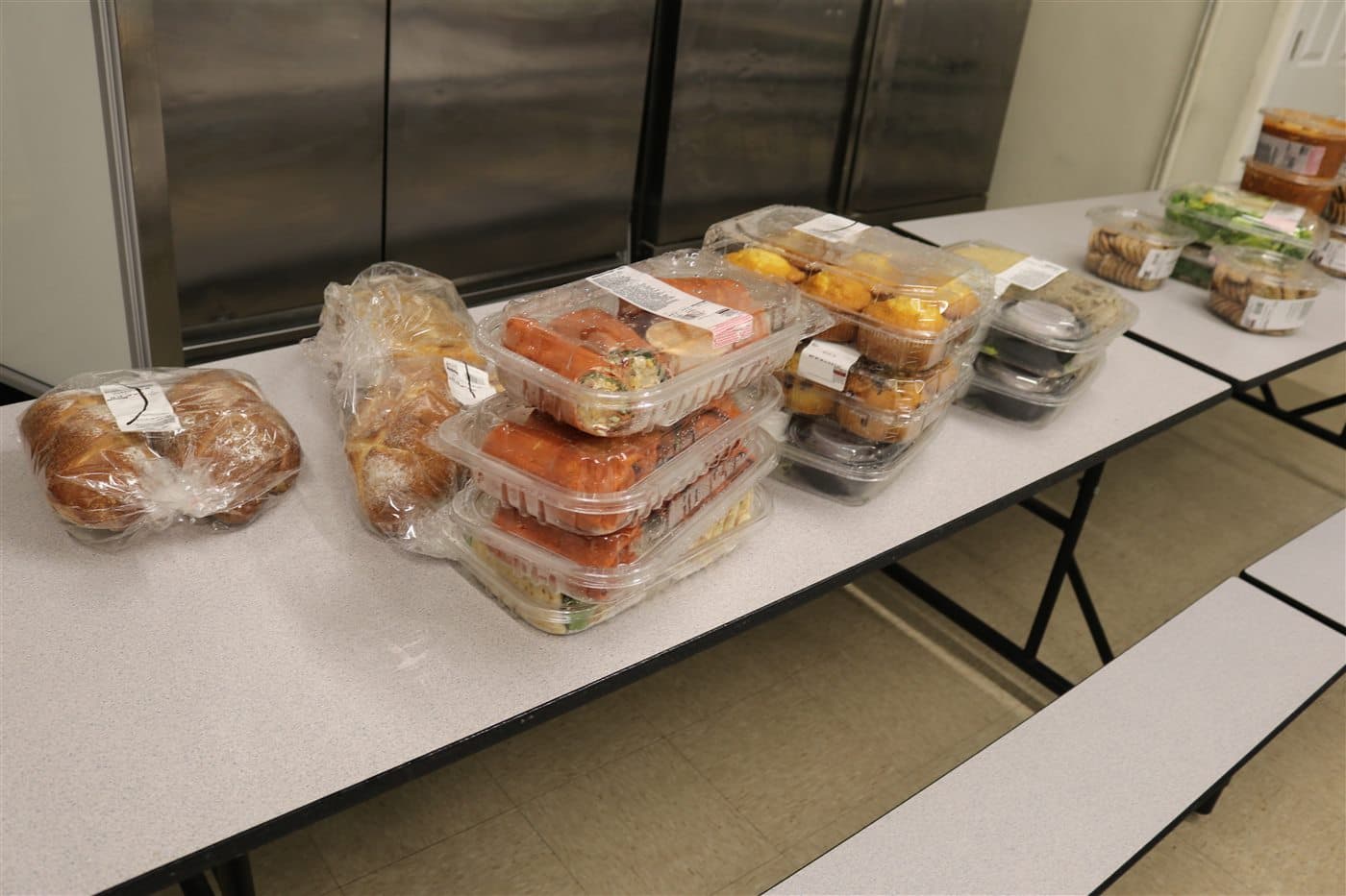 Rows of prepared meals and baked goods arranged on tables