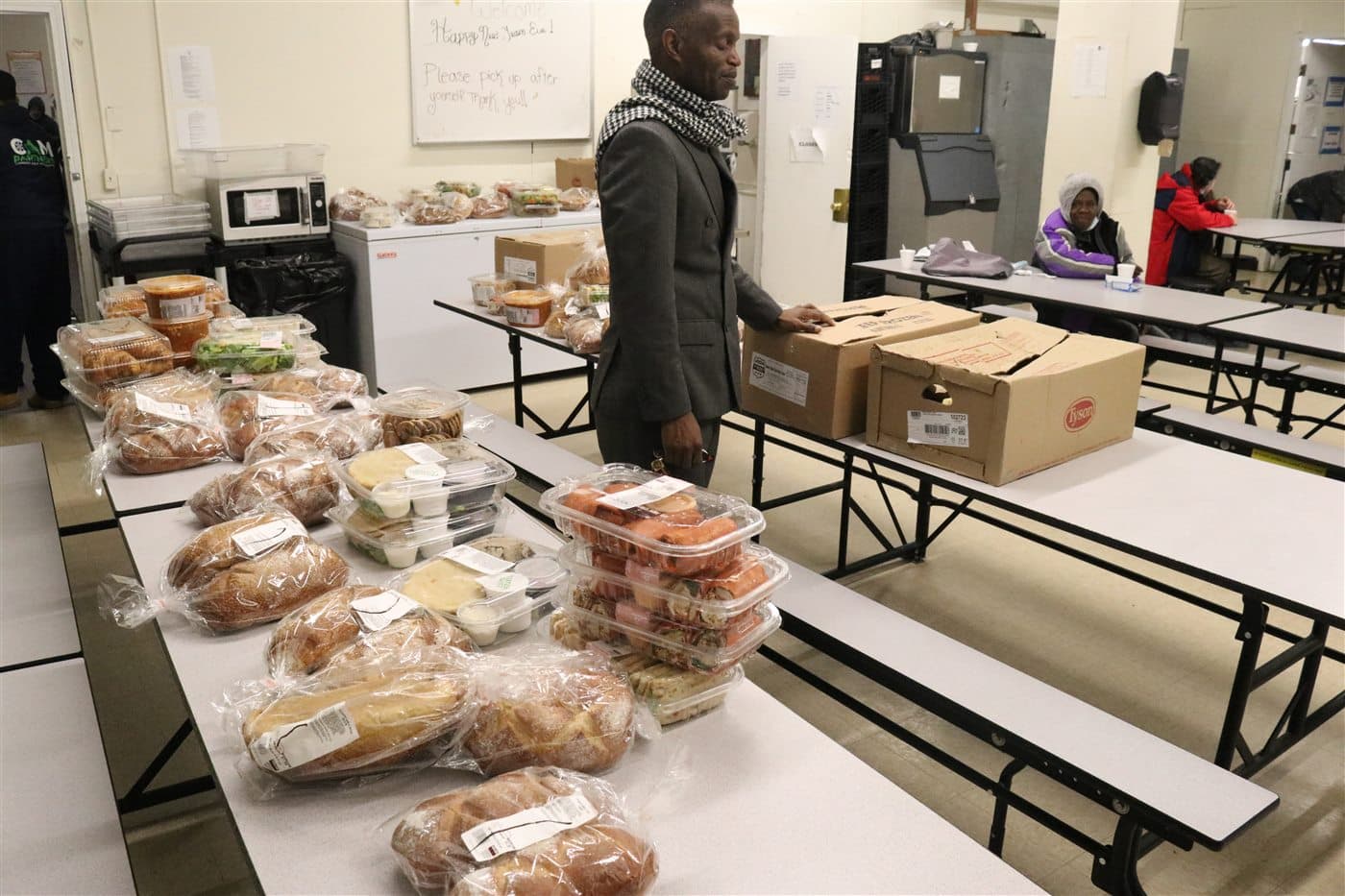 A preparation room filled with food, supplies and packed boxes