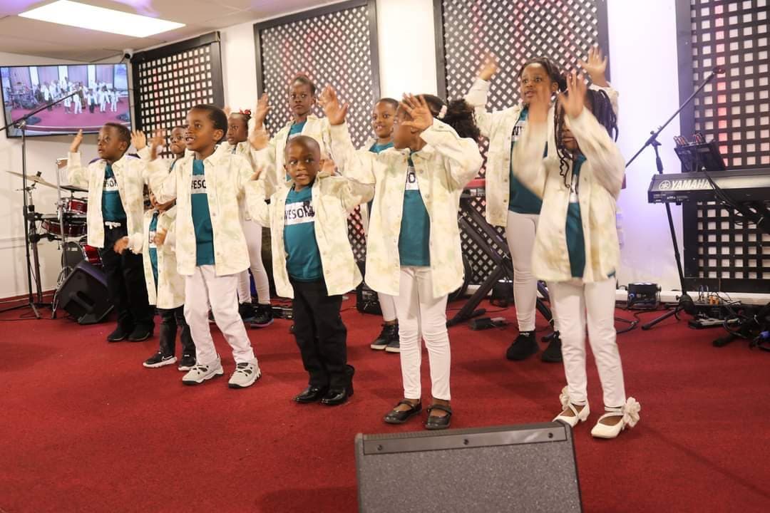 Youth performing a celebratory praise dance in coordinated attire