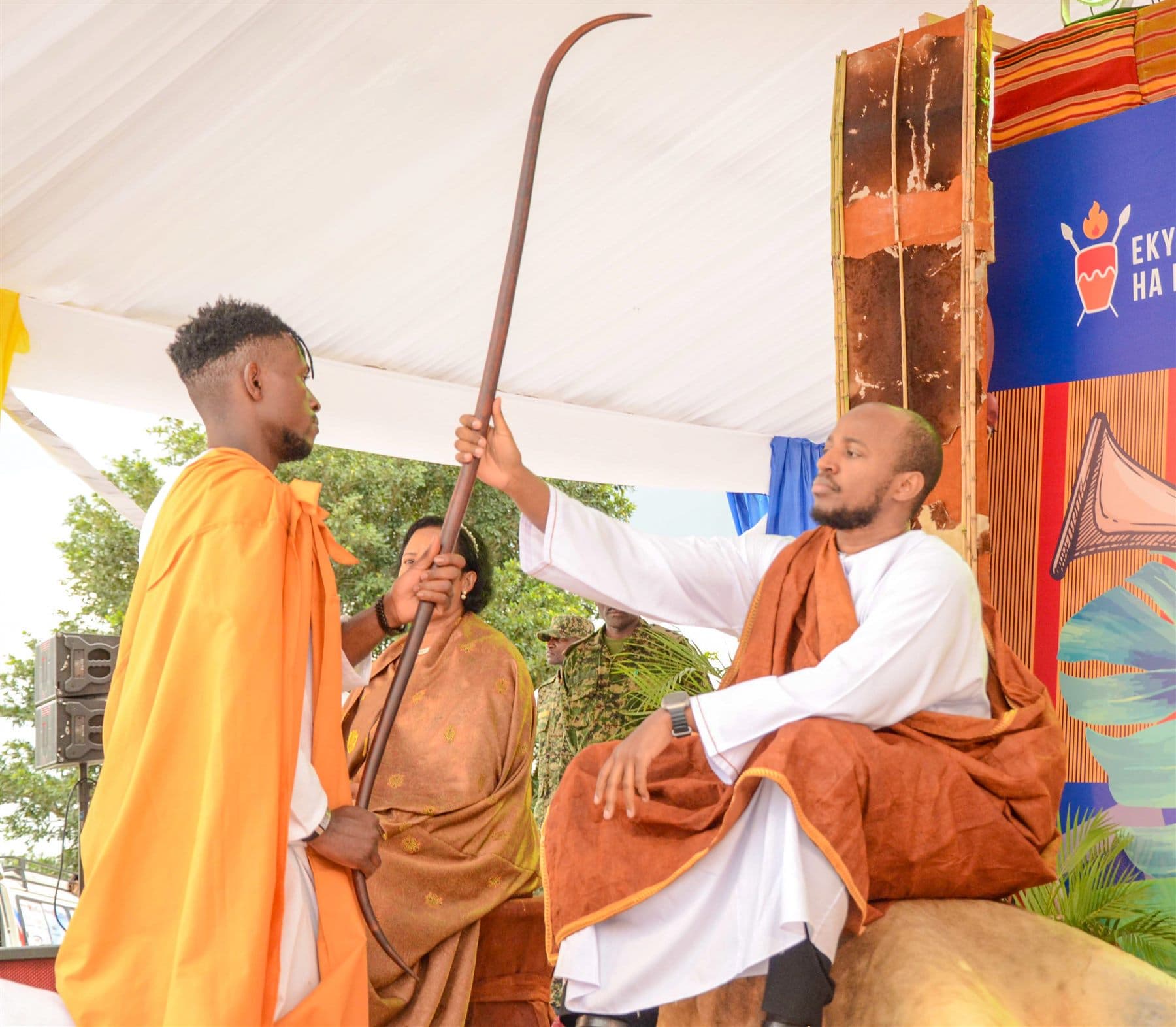 King Oyo seated on the royal stool, extending his hand to bless the royal spear presented to him
