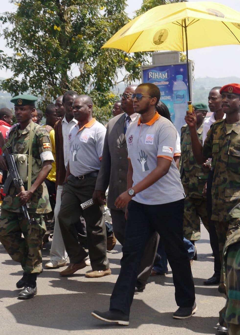 A young King Oyo walking with officials during a child rights march in Fort Portal