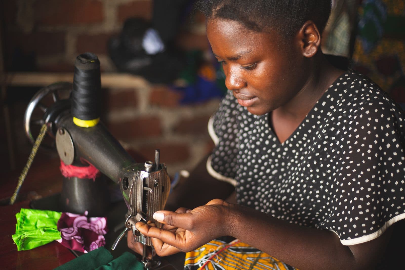 A young seamstress practicing vocational skills in Kasese, Uganda